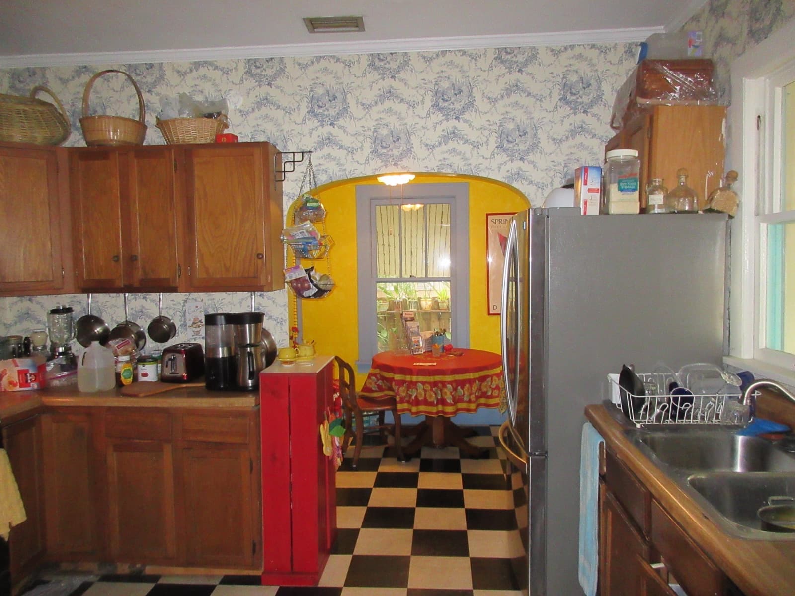 Lived-in kitchen with oak cabinets and a dated dining nook — sell as-is, no need to renovate first